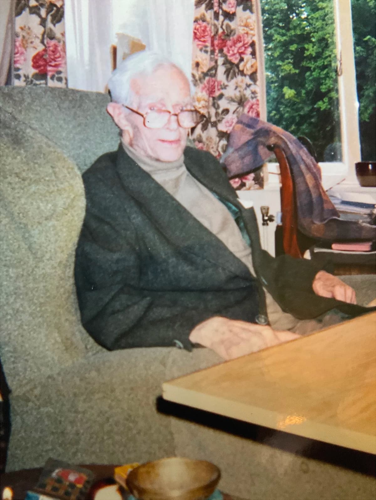 Owen Barfield seated in an armchair at home in later life